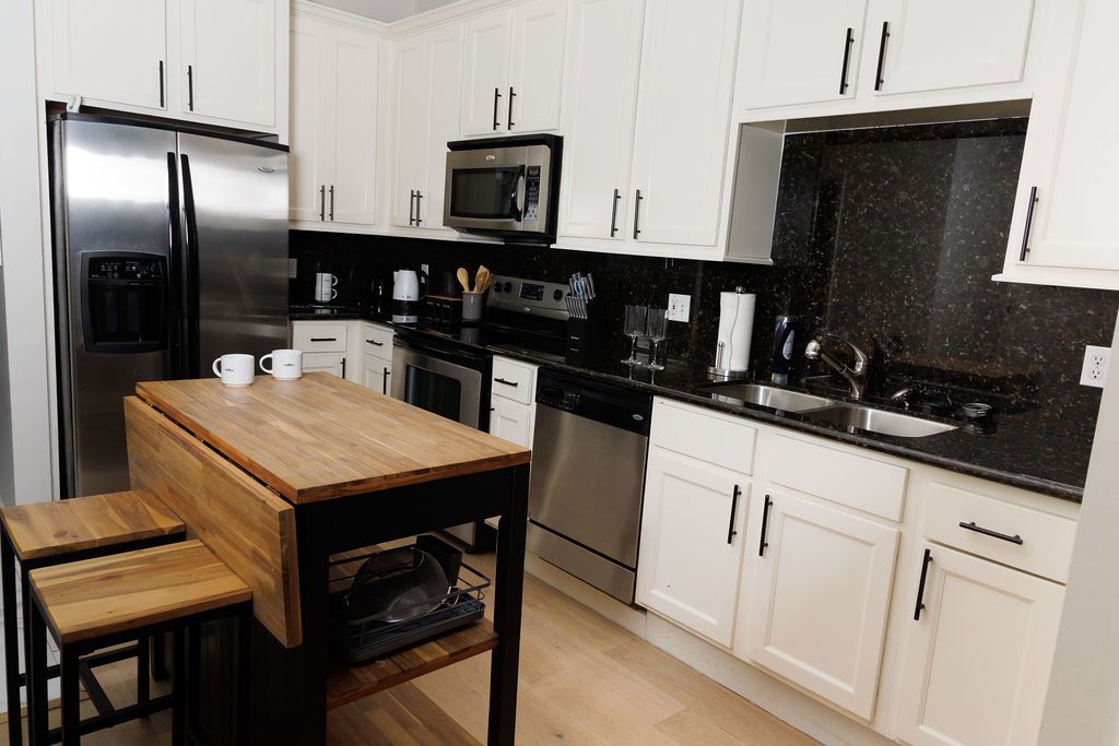 Full kitchen with stainless appliances and a butcher-block island